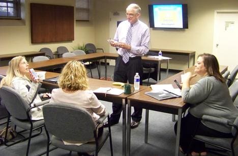 Workshop Instructor & Small Business Marketing/Public Relations Consultant Denis Sweeney answers questions from three workshop attendees.