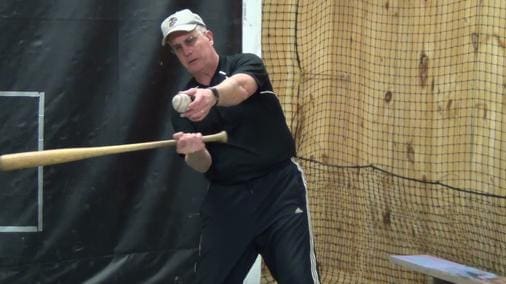 Mark Frampton, a Sweeney Enterprises LLC client, demonstrates the point of impact of a baseball bat striking a baseball.