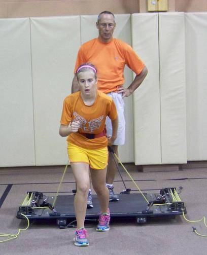 Young female athlete participates in a training exercise under the guidance of coach Lou Fiorillo