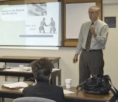 Workshop instructor Denis Sweeney emphasizes a concept during his seminar on Going on the Record with the Media