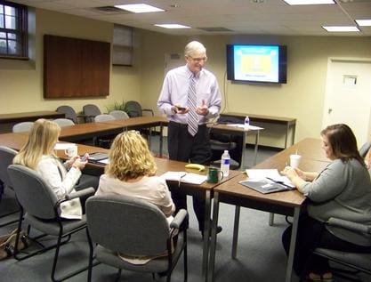 Workshop speaker Denis Sweeney instructs 3 seminar attendees